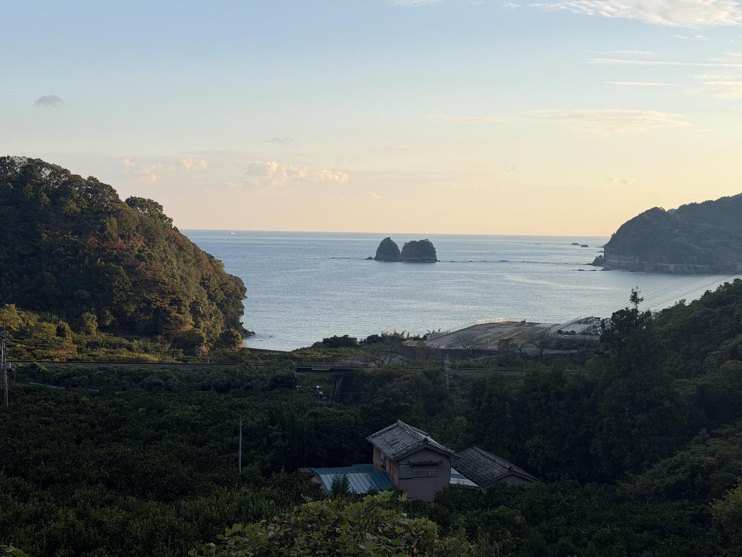 Evening coastal vista with a rocky islet and headlands